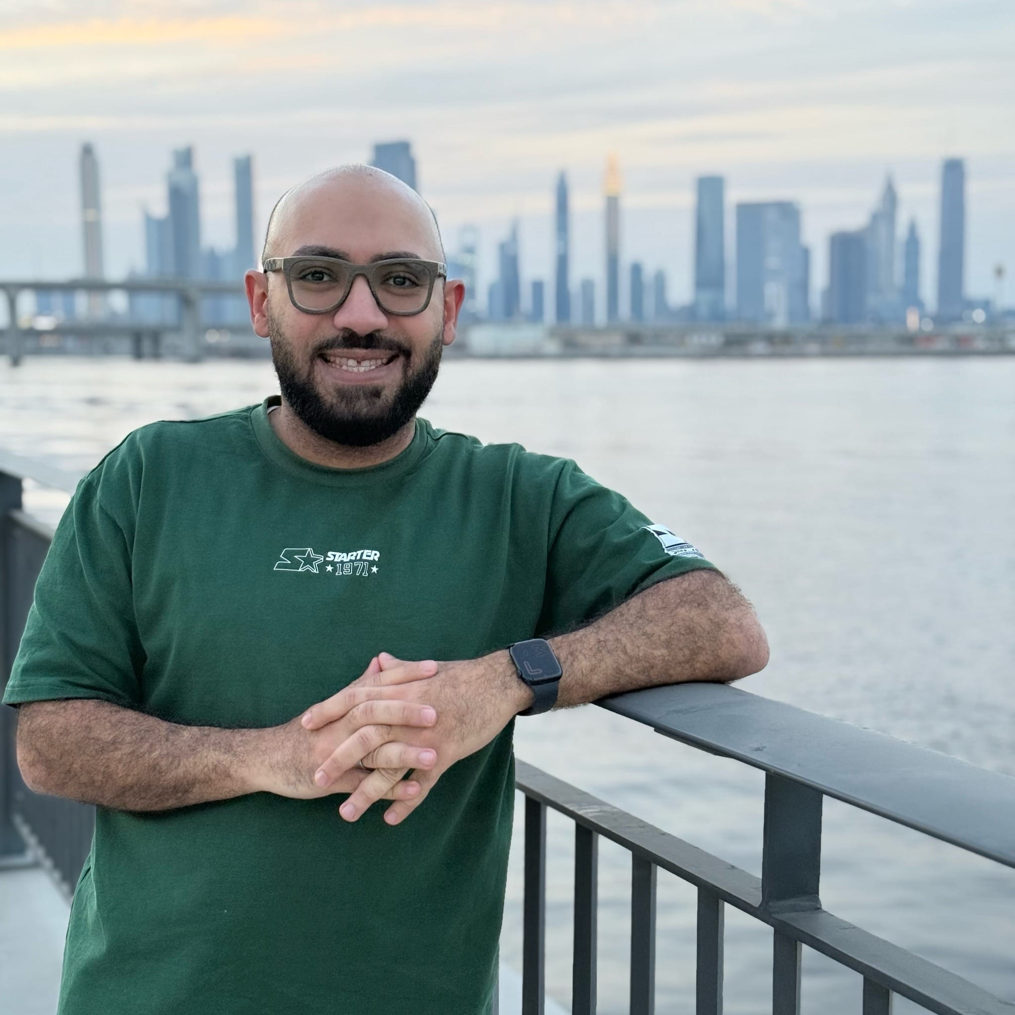 Man standing by waterfront in Dubai.